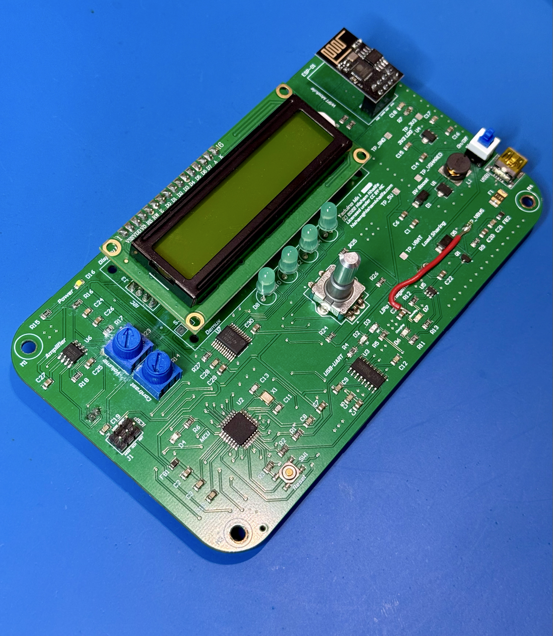 An assembled Yaduino board, complete with a 1602A display and ESP-01 module plugged in. Note the red bodge wire to connect VCC on the charge management IC.